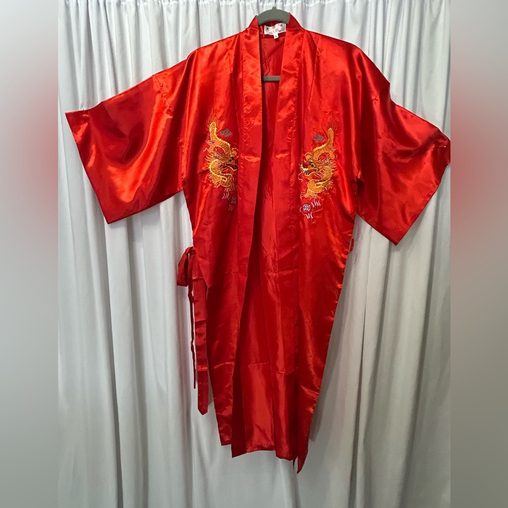Kimono is red and embroidered beautifully. It is a small size.